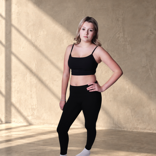 Model wearing Lanula Core Leggings in black with a high-rise waistband and supportive stretch fabric